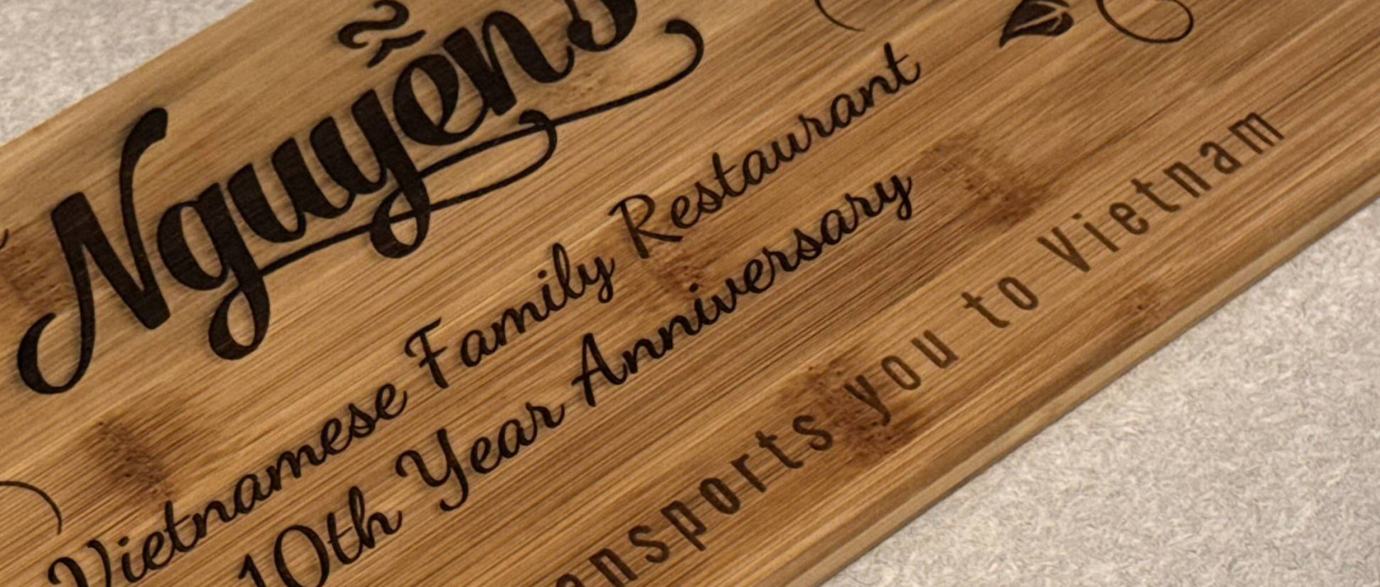 Close-up of a personalized anniversary inscription engraved in wood